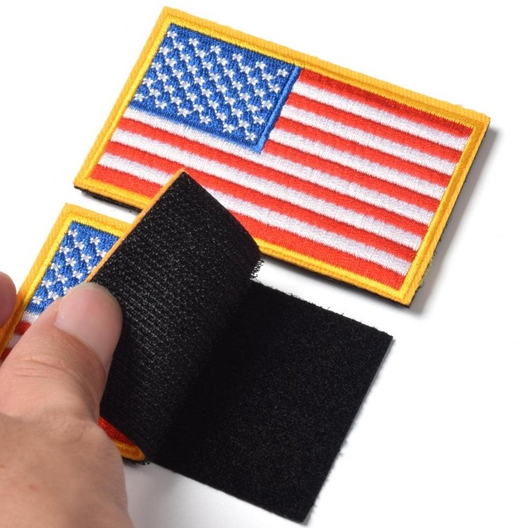 US flag patch with hook and loop backing being peeled