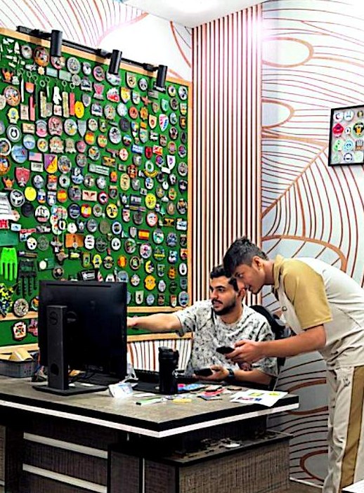 Team reviewing artwork in front of the patch sample wall