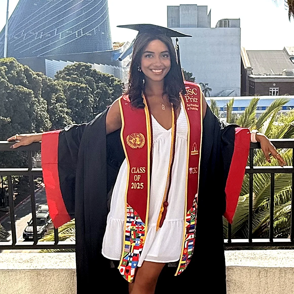 Dhyuthi Chegu in graduation attire on a university terrace