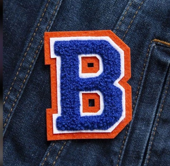 Blue and orange chenille letter B patch on denim